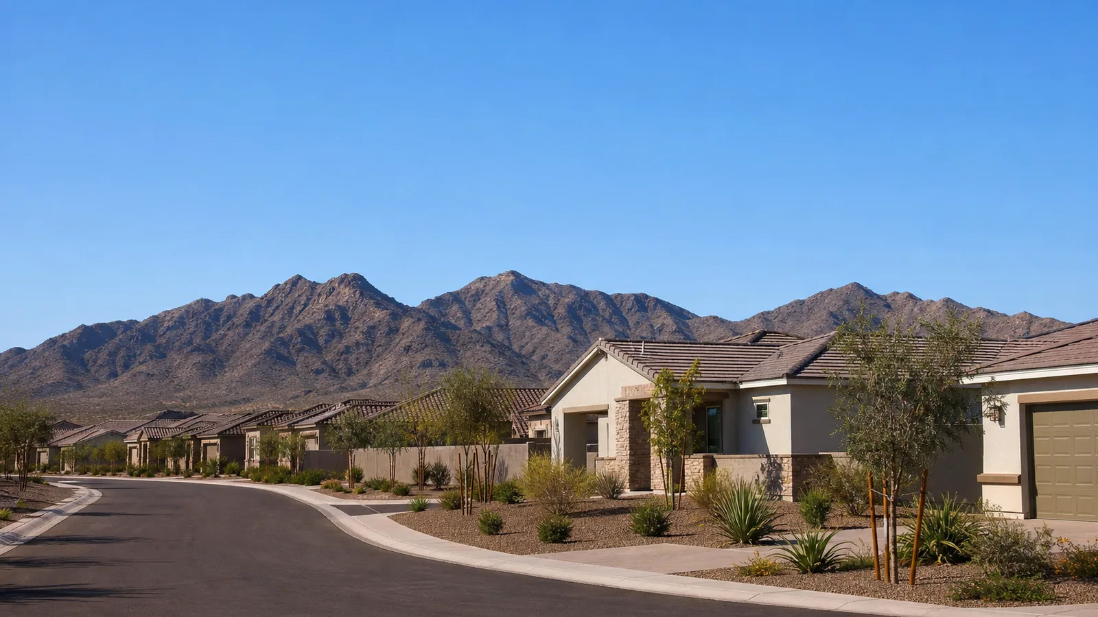 West Valley housing with the Estrella Mountains on the horizon under a wide Arizona sky